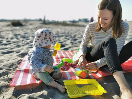 My daughter and fiance playing with toys on a beach in Italy in October.